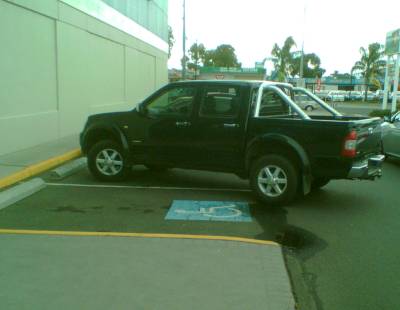Car parked halfway in disabled spot