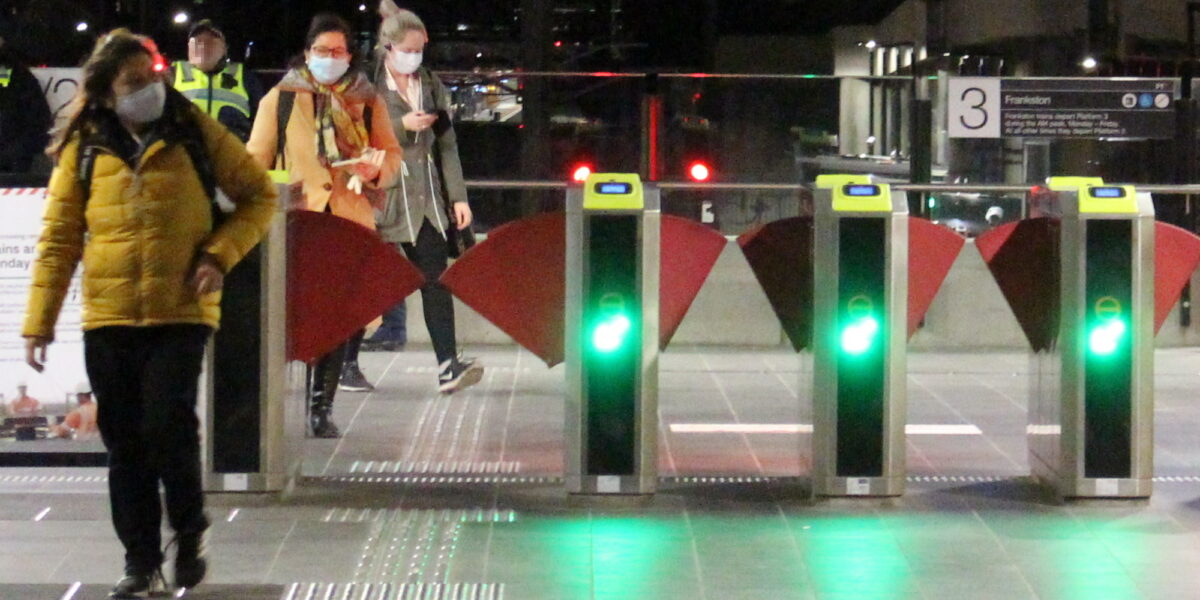 Passengers with masks at station gates