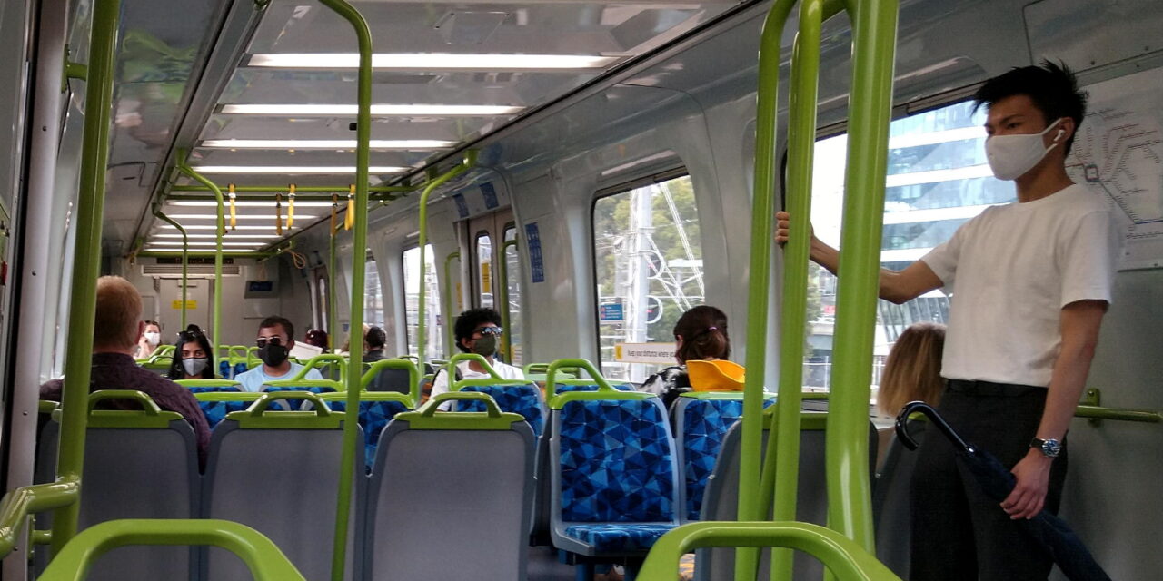 People on a train wearing masks
