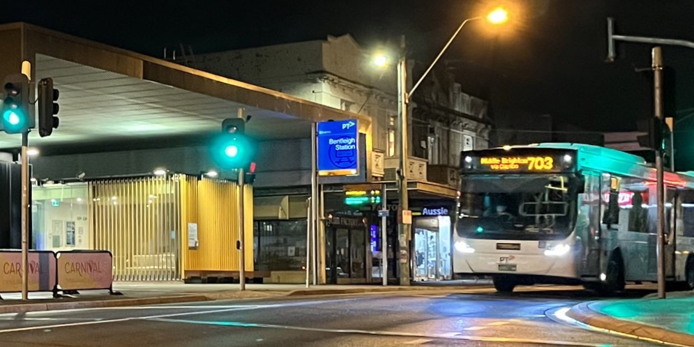 Bus passing station at night