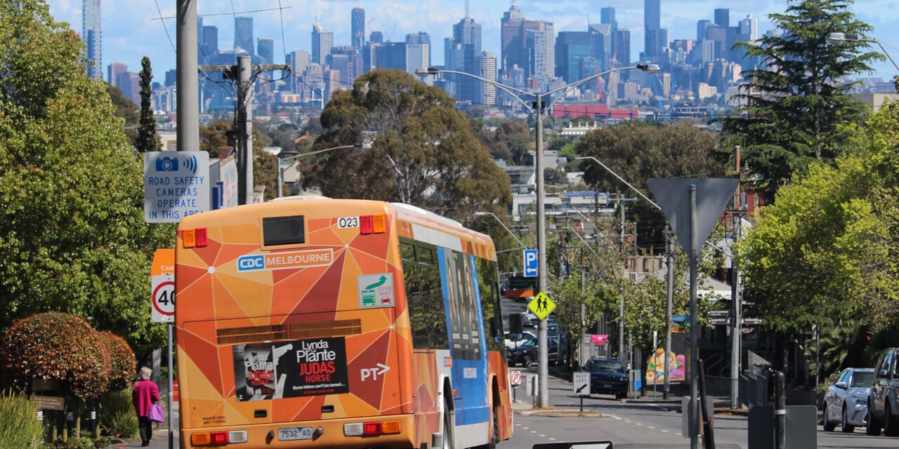 Melbourne bus, with city skyline in the background