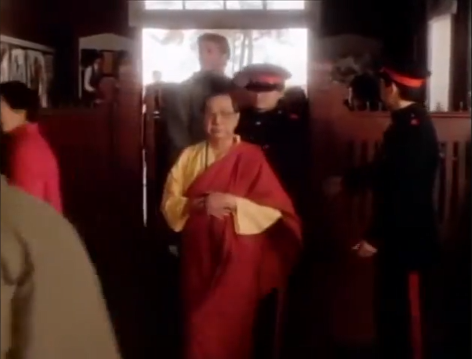 A monk and other characters enter a railway station in a scene from Mission Impossible, filmed at Caulfield Station.