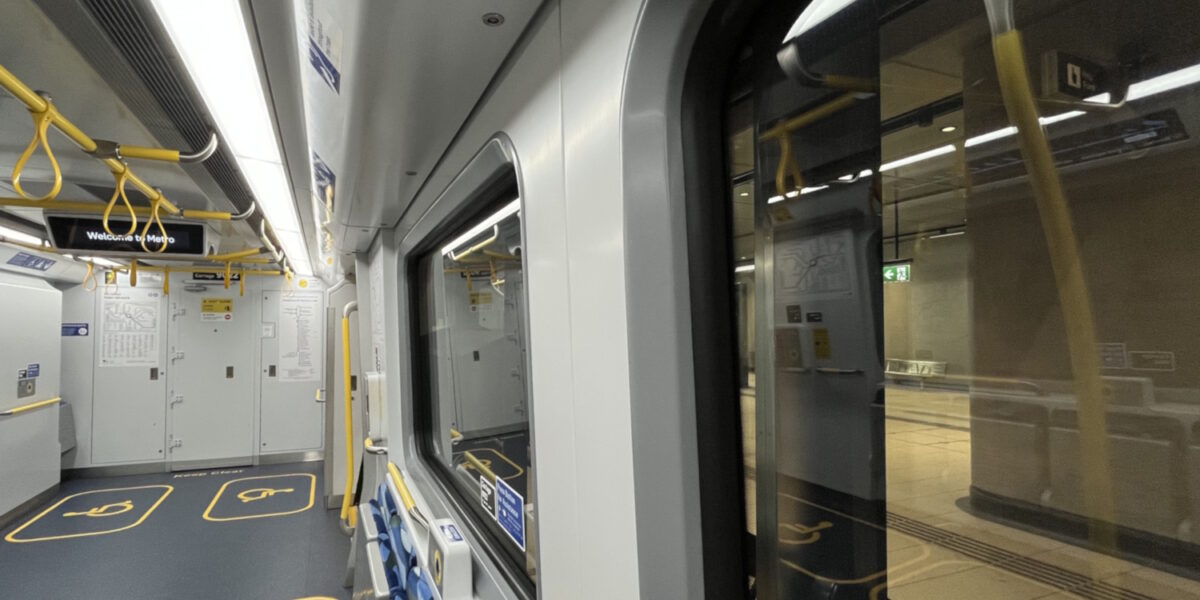 Inside a train at Town Hall station. The display in the train says Welcome to Metro.